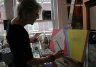 Artist Mary Ann Schindler at work at 447 Studios & Gallery on Race Street. 